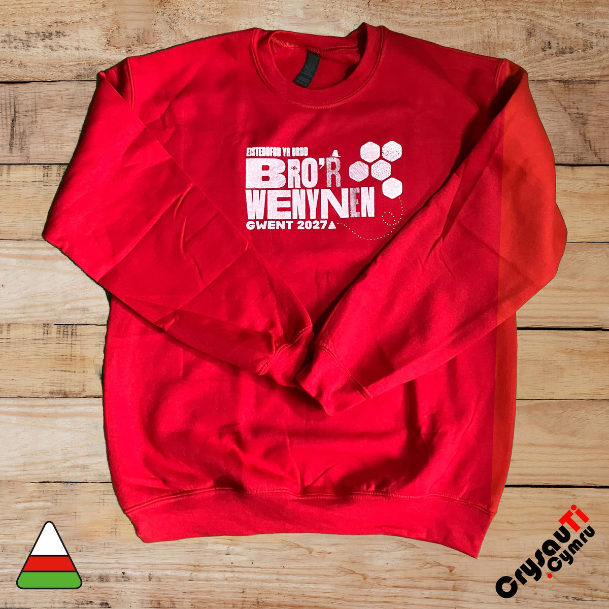 Red jumper featuring Urdd Gwent 2027 Bro’r Wenynen design